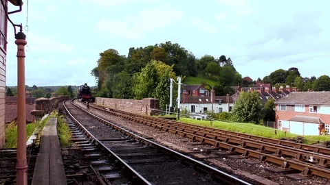 Steam train producing smoke travelling rural railway track Stock Footage 80321672