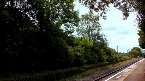 Steam train producing smoke travelling countryside railway track Stock Footage 80322939
