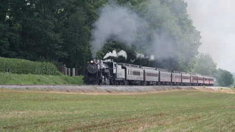 Steam Train Puffing Along Amish Countryside Stock Footage 114567195