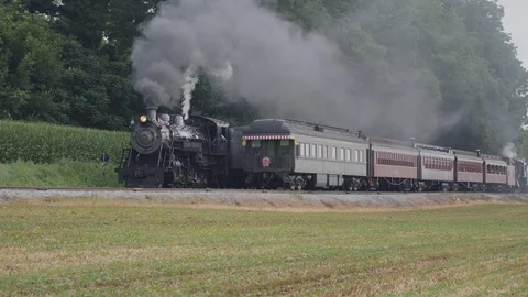 Steam Train Puffing Along Amish Countryside Stock Footage 114567871