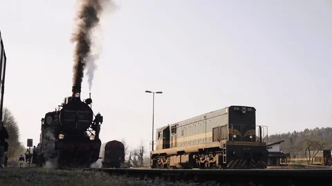 Steam train with smoke on a train station Stock Footage 107154479