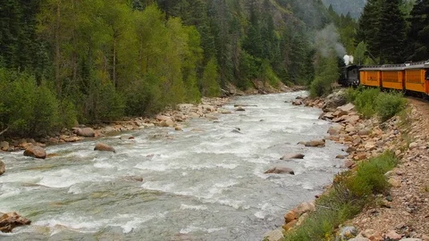 Steam Train stopped by river Video stock 118619370