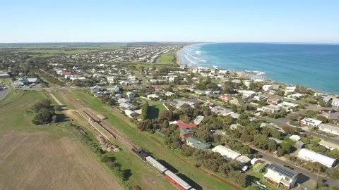 Steam train on tracks next to beautiful ocean 4k Stock Footage 251794743