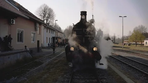 Steam train on a train station - open shot crane Stock Footage 107156339