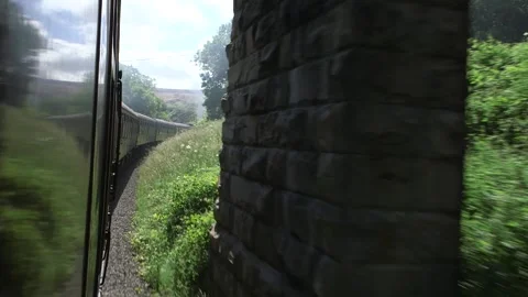 Steam train view from outside window of moving train going under bridge Stock Footage 240415722