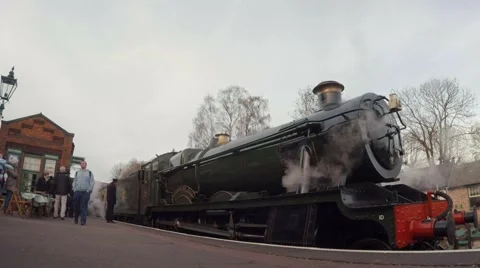 Steam Train waits at platform with passengers walking Stock Footage 57468853