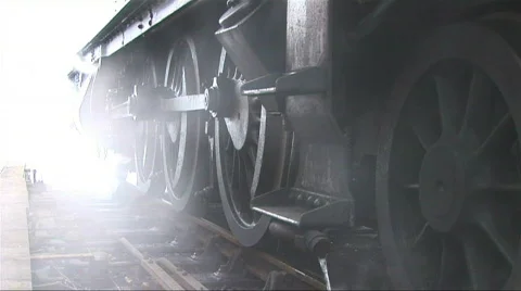 Steam train wheels & smoke Stock Footage