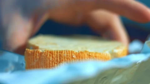 Steam transformation effect of Close-up of hand cutting French cheese Marquis Stock Footage 239982730