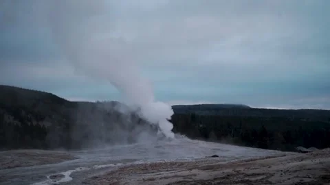 Steam venting from a geyser in slow motion against a dusky mountain valley Stock Footage 344636583