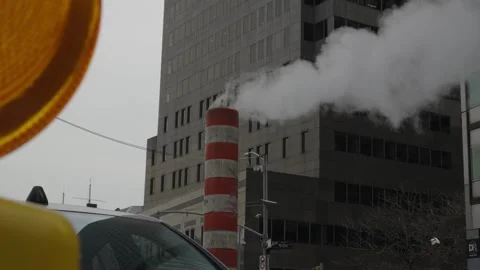 Steam vents from a construction pipe with a foreground of a warning light an Stock Footage 241498104