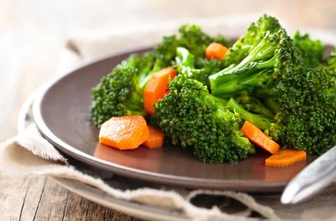 Steamed broccoli on plate. Stock Photos