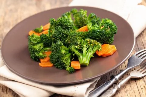 Steamed broccoli on plate. Stock Photos