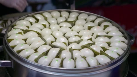 Steamed buns made from flour are cooked in a pot Stock Footage 322778928