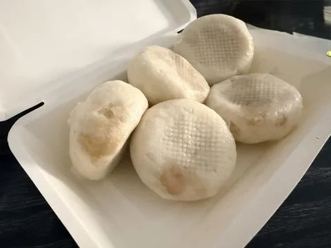 Steamed buns in a white container. Stock Photos