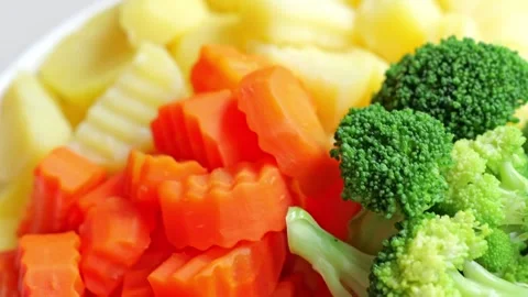 Steamed Carrot Broccoli Vegetable Mix with Orange Potato Crinkle Cut Side Dish Stock Footage 346328367