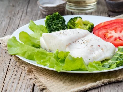 Steamed cod fish. Paleo, keto, fodmap healthy diet with Stock Photos