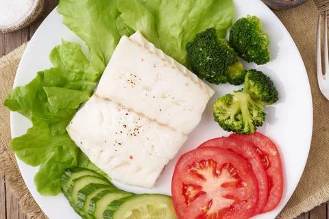 Steamed cod fish. Paleo, keto, fodmap healthy diet with vegetables Stock Photos