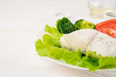 Steamed cod fish. Paleo, keto, fodmap healthy diet with vegetables Stock Photos