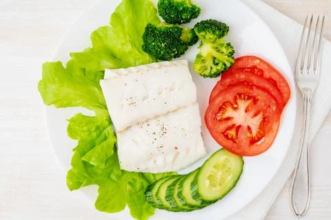 Steamed cod fish. Paleo, keto, fodmap healthy diet with vegetables Stock Photos