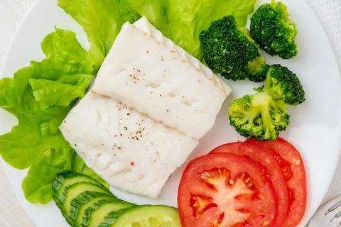 Steamed cod fish. Paleo, keto, fodmap healthy diet with vegetables Stock Photos