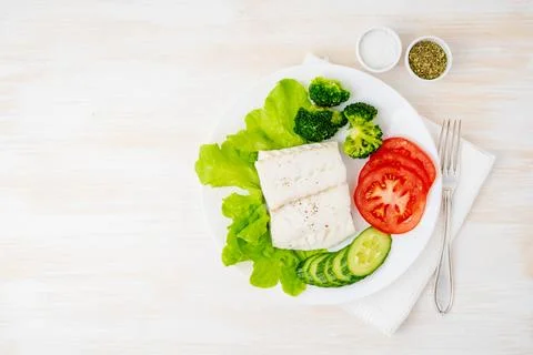 Steamed cod fish. Paleo, keto, fodmap healthy diet with vegetables Stock Photos