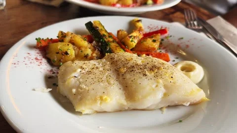 Steamed cod with grilled vegetables and aioli sauce, healthy tasty food. Stock Footage 306603285
