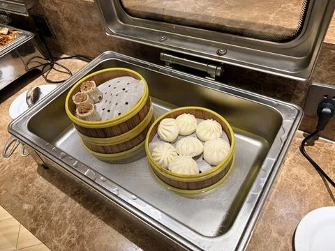 Steamed Dim Sum in Bamboo Baskets on a Buffet Tray. Stock Photos