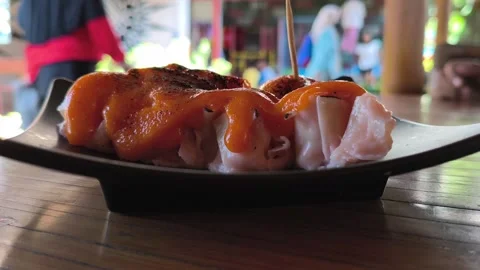 Steamed Dim Sum with Mentai Sauce on a Wooden Table Stock Footage 338378607