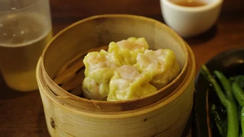 Steamed Dumplings and Drinks on Restaurant Table in Beijing, China Stock Footage 345744799
