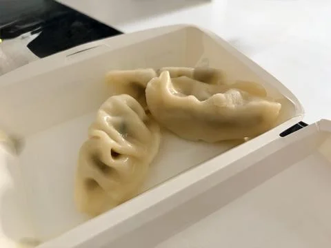 Steamed Dumplings in Takeout Container Stock Photos