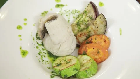 Steamed fish fillet served with baked vegetable garnish Stock Footage 313655901