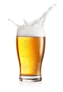 Steamed glass of light beer with splash Stock Photos