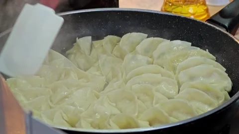 Steamed Gyoza or dumpling stuffed ground pork dipping with garlic soy sauce. Stock Footage 304593064