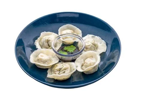 Steamed handmade dumpling served in a dish isolated on white background side  Stock Photos