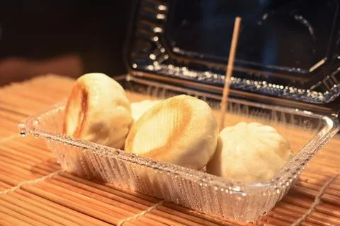 Steamed mini dumplings in a plastic container Stock Photos