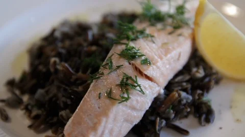 Steamed red fish, served with black rice and lemon. high protein foods. the Stock Footage 114700272