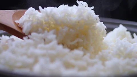 Steamed white rice in a pot with soft steam and wooden spoon Stock Footage 326705628