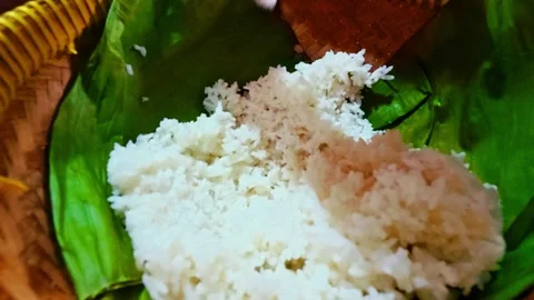 Steamed white rice served on green banana leaf in traditional style Stock Footage 346741399