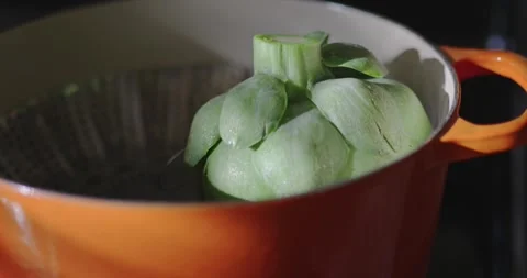 Steaming artichoke with window light shinning in kitchen Stock-Footage 306260272