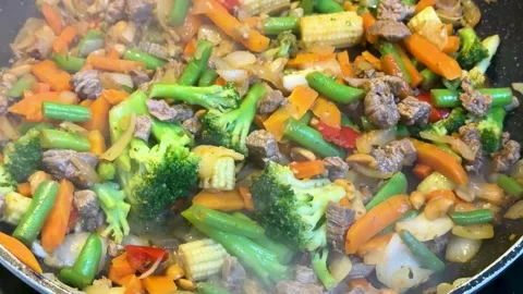Steaming Beef and Vegetable Stir Fry Cooking in a Pan Stock Footage 341395281