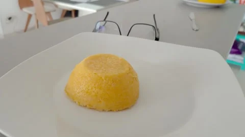 Steaming Brazilian corn couscous on a plate beside a pair of glasses. Stock Footage 321661230