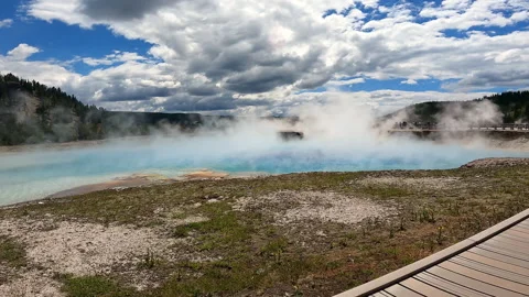 Steaming bright blue geothermal hot spring pool under a dramatic cloudy sky i-23 Stock-Footage 346102393