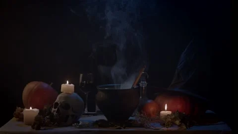 Steaming cauldron between candles and pumpkins Stock Footage 141292966