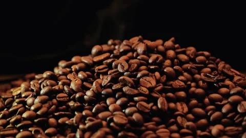 Steaming coffee background.Coffee beans with smoke on a black background Stock Footage 290039041