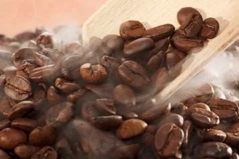 Steaming coffee beans with a scoop Stock Photos