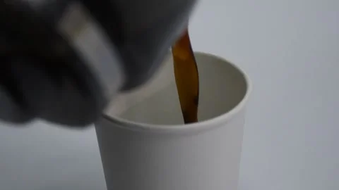 Steaming coffee being poured from a pot into a glass cup Stock Footage 305778178