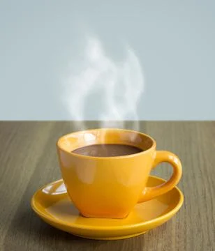 Steaming coffee cup on table Stock Photos