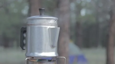 Steaming coffee pot on a camp stove Stock Footage 41423516
