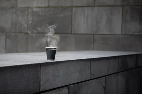 Steaming Coffee sitting on a brick wall Stock Photos