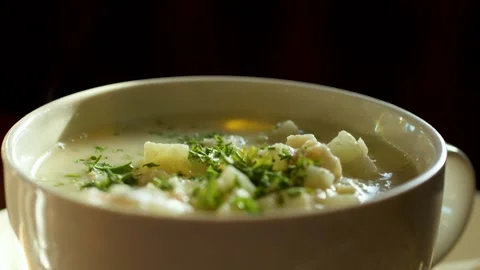 Steaming Creamy Chowder in White Bowl with Fresh Herbs Stock Footage 320031753